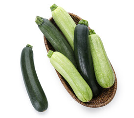 Wicker bowl with fresh green zucchini on white background