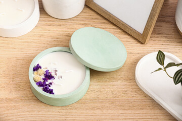 Holder with candle and decor on wooden background, closeup