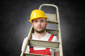 Clumsy construction worker standing with a ladder © Designpics