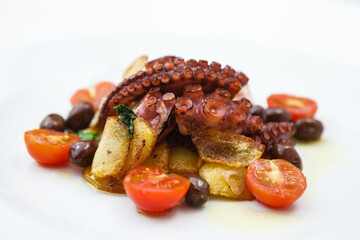 Grilled octopus with cherry tomatoes and potatoes