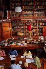 Professor having class in library.