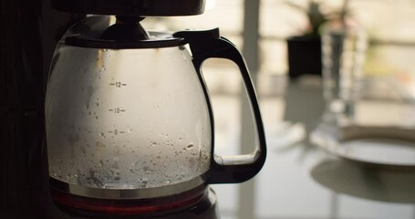 Preparing delicious invigorating filter coffee in the kitchen at home. Americano coffee for breakfast before work. High quality 4k footage