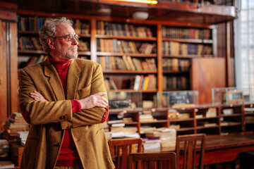 University professor in library with copy-space.