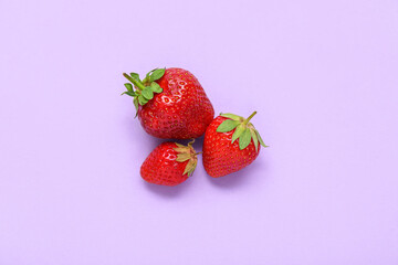 Fresh strawberries on lilac background