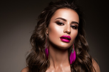 Fototapeta premium Beauty Woman face Portrait. Beautiful model Girl with Perfect Fresh Clean Skin color lips pink. Brunette long hair. Isolated on beige background