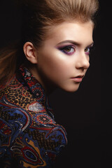 Studio Portrait of a beautiful young model girl with glamorous evening makeup