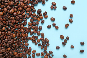 Scattered coffee beans on blue background
