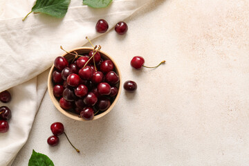 Bowl with sweet cherries on white background