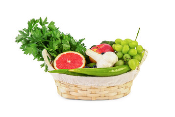 Wicker basket with different fresh fruits and vegetables on white background