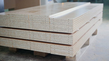 Stack of wood particleboard panels on the warehouse or factory, industrial concept