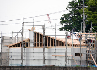 Wooden new construction site with scaffolding.