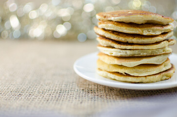 Fried pancakes are a mountain on a plate of sweets for a healthy breakfast