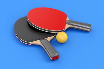 Pair of table tennis rackets and ball on blue background