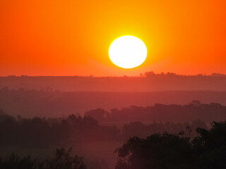 Closeup of the sun setting over the horizon