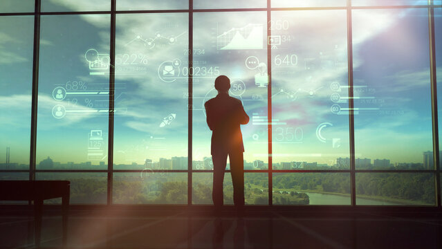 The illustration shows the silhouette of a businessman on the background of corporate infographics.