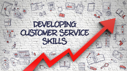 White Brick Wall with Developing Customer Service Skills Inscription and Red Arrow. Success...