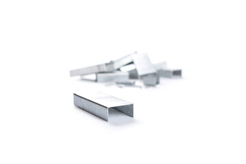 Stack of metal staples. Isolated on a white background.
