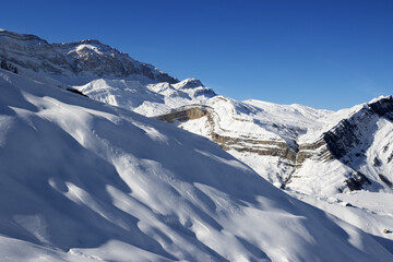 Naklejka premium Off-piste slope at nice sun evening. Greater Caucasus, Mount Shahdagh. Qusar rayon of Azerbaijan.
