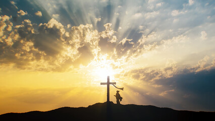Silhouette of a woman praying at Holy Cross.