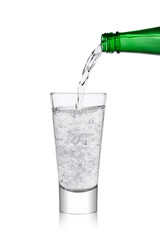 Pouring lemonade soda drink sparkling water from bottle to glass