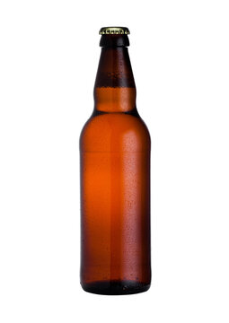 Brown glass lager beer bottle with black cap isolated on white background with dew
