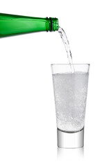 Pouring lemonade soda drink sparkling water from bottle to glass