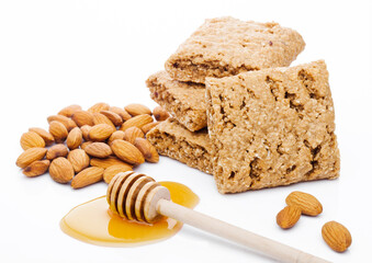 Fototapeta na wymiar Healthy bio breakfast grain biscuits with honey and almonds on white background