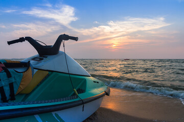Jet ski on beach against blue sky and sunset