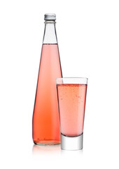 Bottle and glass of sparkling pink soda drink lemonade on white background