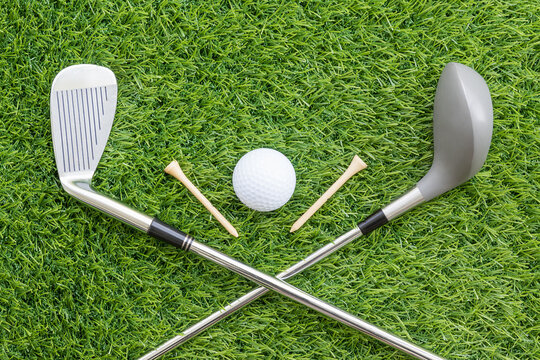 Sport objects related to golf equipment ,Golf club and ball on green grass