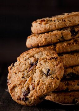 Gluten free oatmeal chocolate cookies with rasins on a old wooden background