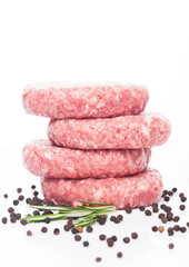 Raw fresh beef burgers with pepper and rosemarine on white background