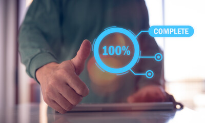Man give a thumb up stamp on screen of project complete 100 percent