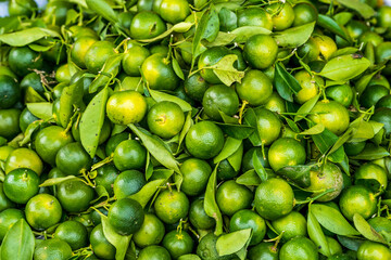 Bunch of fresh green limes on market