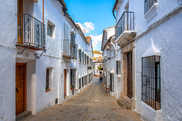 A long narrow alley leading to the town square at the Spanish White Village of Grazalema, Spain, in the Andalucian region of Southern Spain.