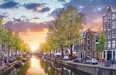 Fototapeta premium Channel in Amsterdam Netherlands houses river Amstel landmark old european city spring landscape.