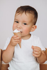 
portrait of a boy biting a waffle cone with ice cream