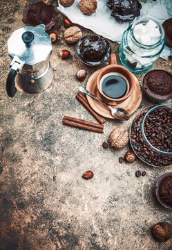 Crafting coffee in clay cup with bean cezve and chocolate cake top view on grunge background.