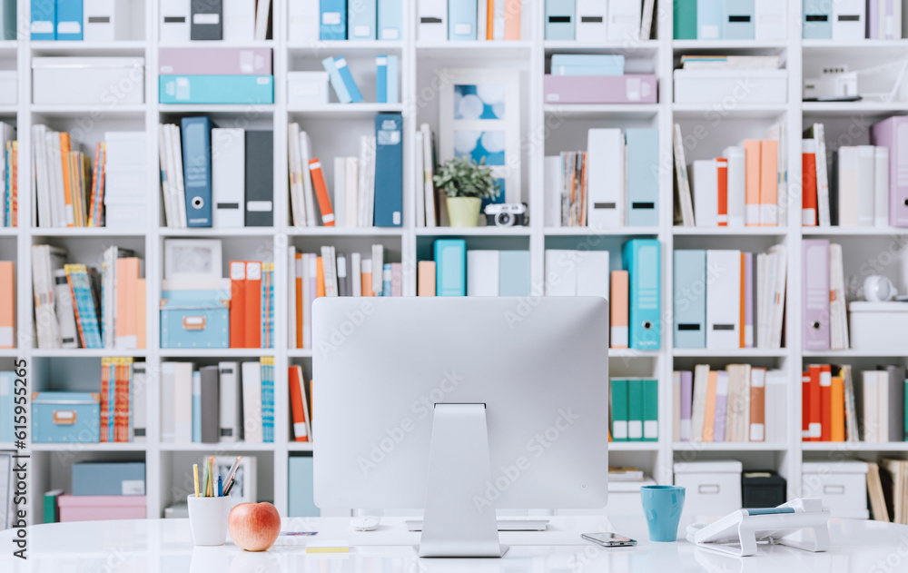 Poster professional creative contemporary workspace with computer on a desk and colorful folders on the bac