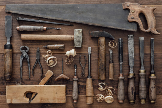 Collection of vintage carpentry tools on an old workbench: woodworking, craftsmanship and handwork concept, flat lay