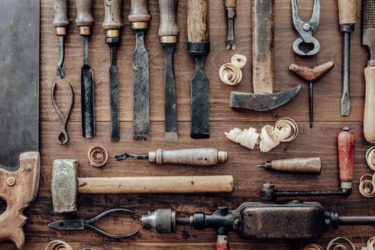 Set of vintage carpentry tools on a old workbench: woodworking, craftsmanship and handwork concept, flat lay