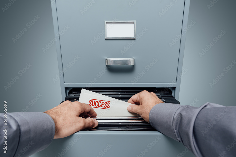 Poster office clerk searching for files in the filing cabinet, he finds a folder with a successful business