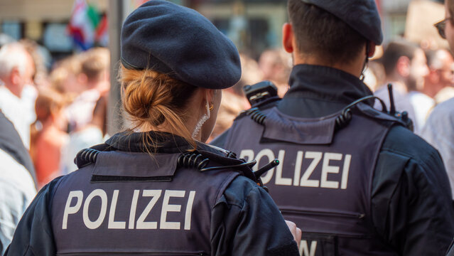 German police officers on duty on the street. ("POLICE" in German)