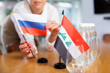 Unrecognizable woman preparing room for international negotiations and communication discussions of...