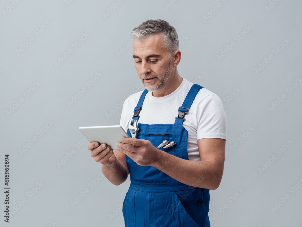 Aufkleber confident plumber or mechanic connecting with a digital tablet and using apps