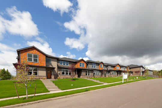 Row of brand new townhomes for sale in North America suburban neighborhood