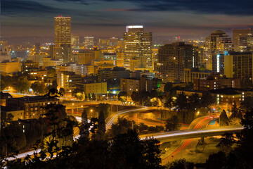 Portland Oregon downtown cityscape and freeway with light trails at night