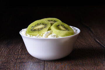 Pieces of kiwi in cottage cheese rustic style