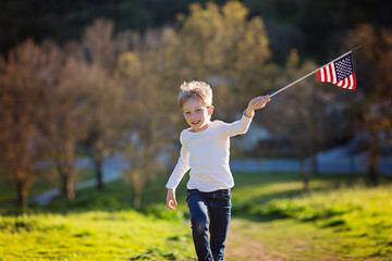 positive little boy with american flag running and celebrating 4th of july, independence day, or memorial day