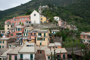 Fototapeta premium Church on hill and rooftops in high density housing in hillside historic Italian fishing village